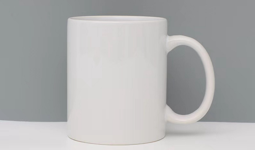 A stack of plain white ceramic mugs ready for customization.