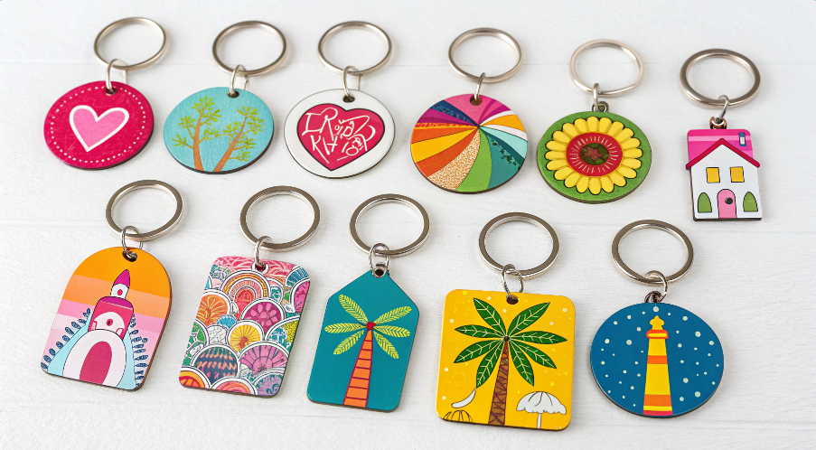 An assortment of brightly-colored, sublimated keychains made from different materials like MDF and metal.